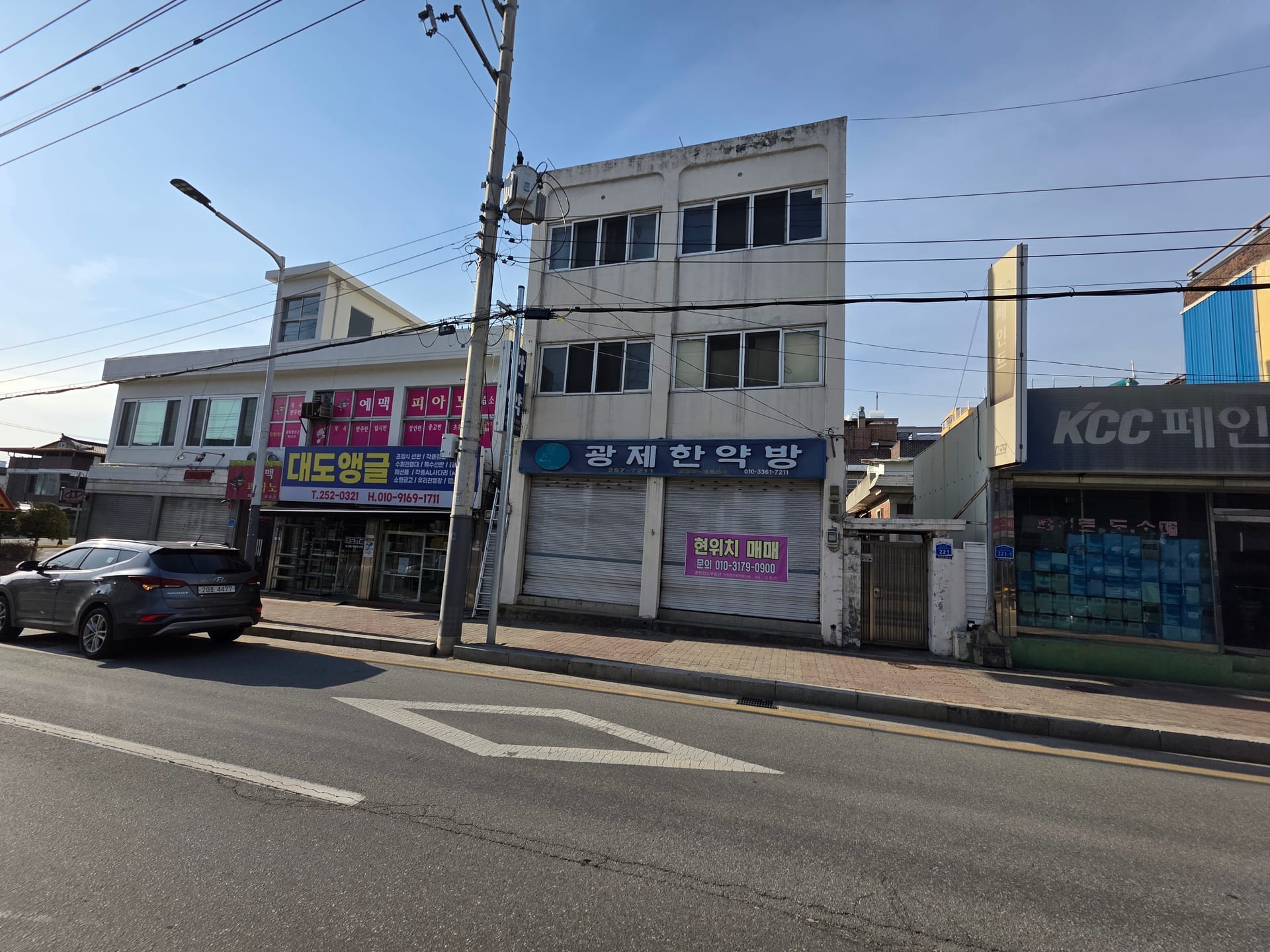 3-story commercial and residential building on a main road — image 2