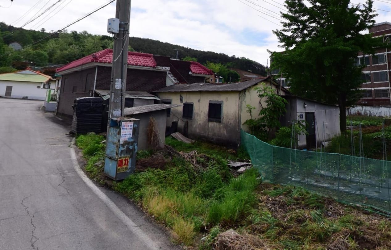 Cement block house adjacent to road