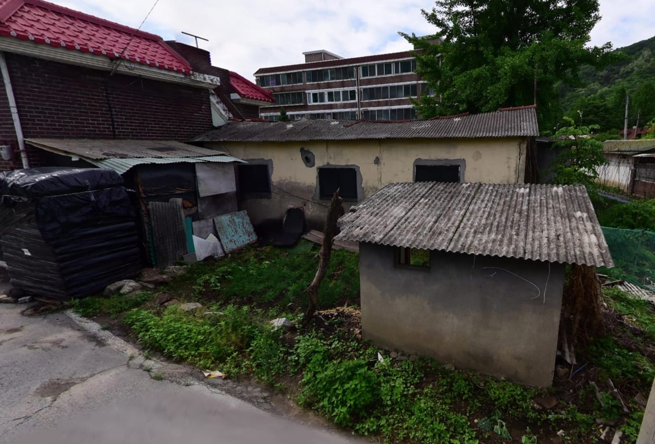 Cement block house adjacent to road — image 2